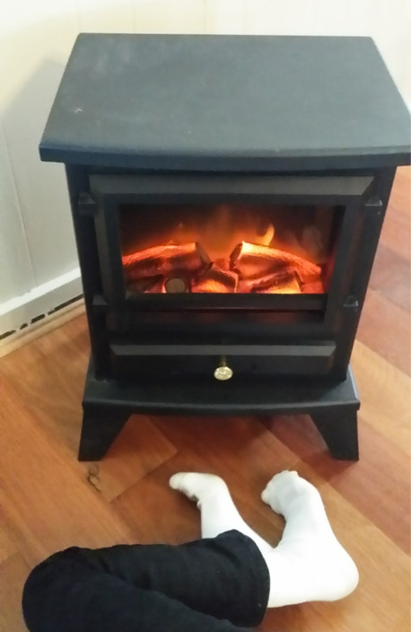 Laurel Cottage Pic 1 - My daughter making herself at home in front of the fireplace heater on a cold winters day