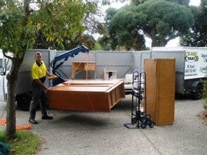 Trash Taxi Pic 3 - Stuart loading furniture using the crane on the Trash Taxi truck