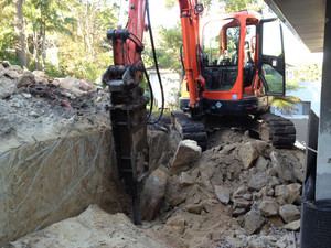 Wright Earthmoving nsw Pic 4 - Hammering the cut rock around the house