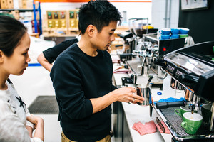 The Espresso School Pic 2 - Barista trainer showing students how to steam milk