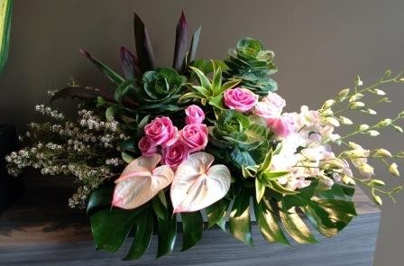 Enchanted Rose Pic 1 - Beautiful arrangement in a ceramic vase with pink roses orchids and antheriums with monsterio leaves