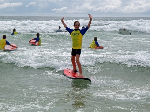 Port Macquarie Surf School Pic 1 - First time standing up at Learn to Surf School Port Macquarie Surf School