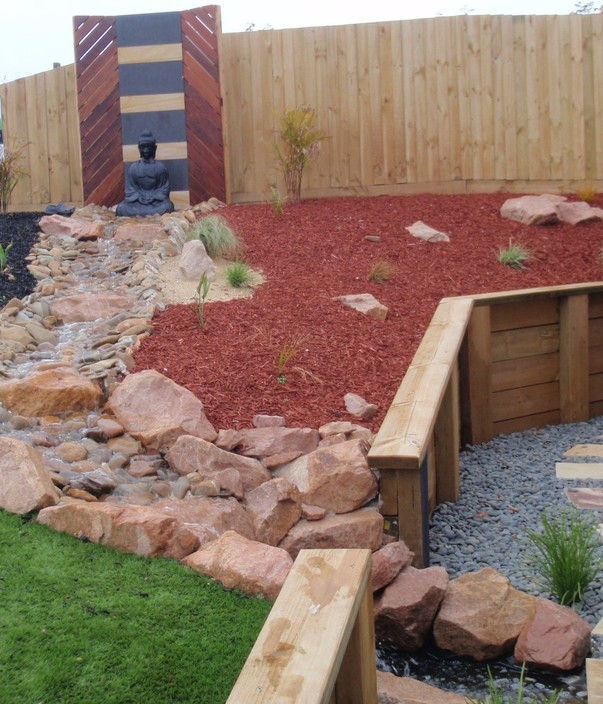 101 Mini Digger and Gardens Pic 1 - Pink granite water feature with decorative screening