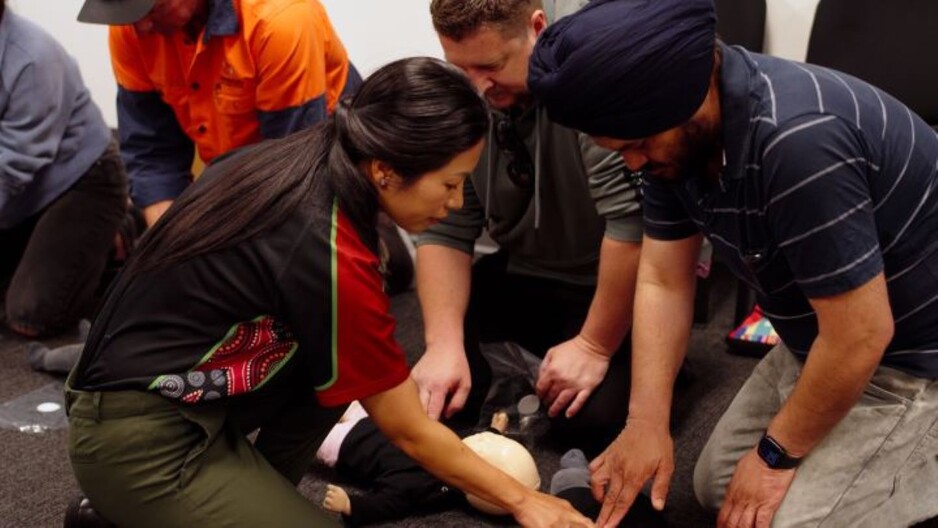 FirstAidPro - Ipswich Pic 1 - Training first aid female teacher showing students correct CPR on baby FirstAidPro Ipswich