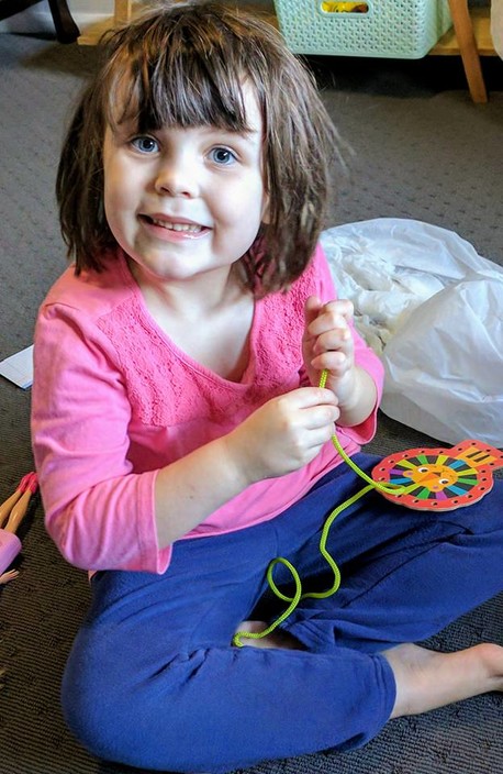 Sunshine Bridge Education Pic 1 - One of our students practising her threading for fine motor and visual perception