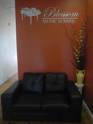 Blossom Music School Pic 3 - Our comfy couch where students relax before going into their lessons