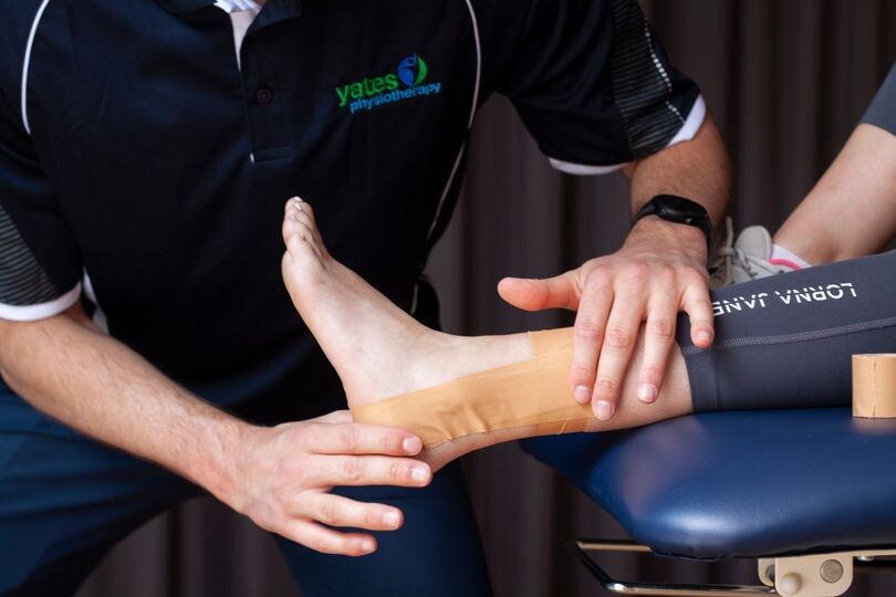 Yates Sports Physio Adelaide Pic 1 - Closeup of a sports physio treating a sprained ankle at a sports injury clinic in Adelaide