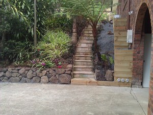 Urban Sanctuary Landscaping Pic 3 - A feature wall of bush rock in a tropical garden