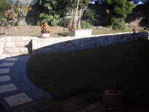 Shade Pro Landscaping Pic 2 - Nice turf and a nice rock wall makes a big difference