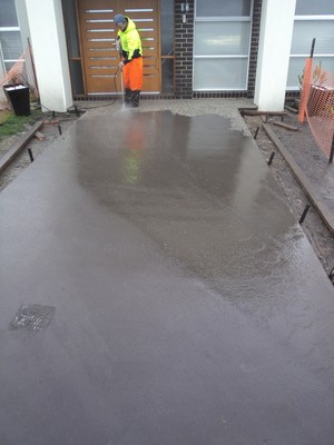 P.A.K. Concreting Pic 3 - washing the cream off the concretegetting it ready for a acid wash