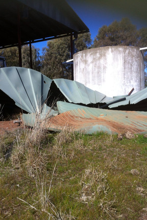 Town & Country Concrete Water Tanks Pic 5 - plastic tank undermined by rabbits resulting in tank splitting in half The concrete tank beside unaffected even though rabbit burrows were evident under Dubbo