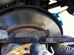 Mobile Car Mechanic Pic 3 - Replacing rear pads discs and sensor on BMW 120i 2009