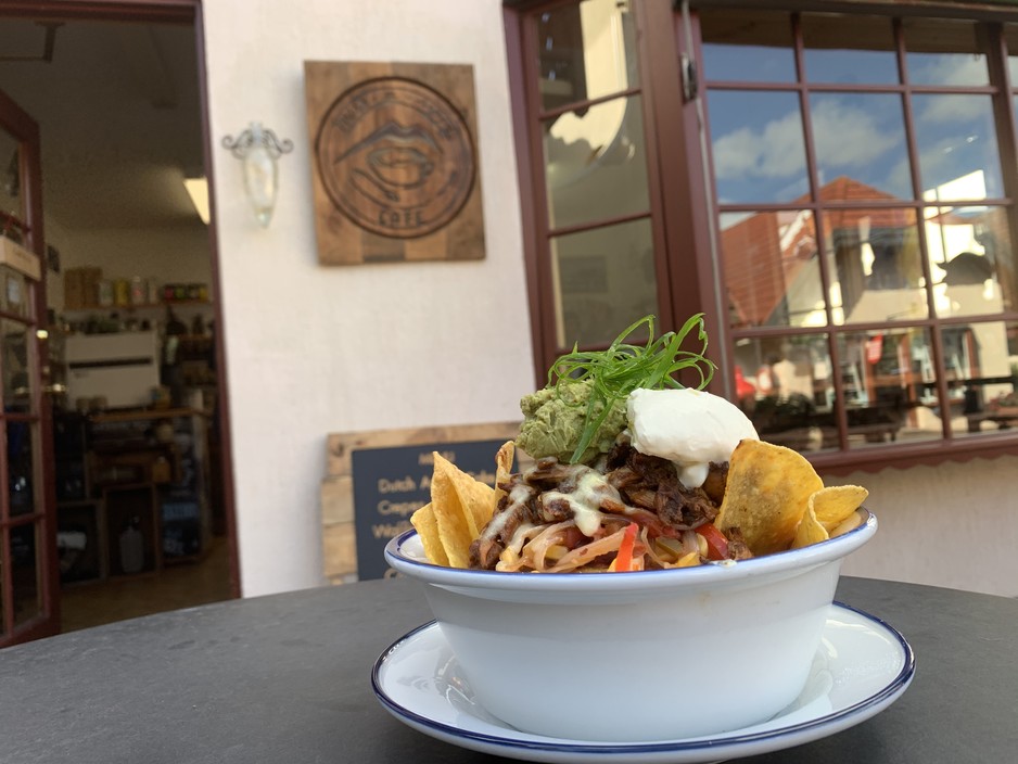 Miss-a-Sippy Cafe Pic 1 - Spicy chilli chipotle chicken fresh Nachos With guacamole sour cream kidney beans and Mexican sauce