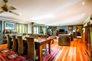 Guy Saddleton Real Estate Pic 2 - This open plan living formal dining area enjoys polished timber floors and central skylight with no less than 5 door options onto the covered verandahs