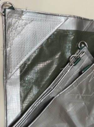 Econotarps Pic 4 - Heavy Duty Tarpaulin 220gsm Silver top side Olive Green underneath Eyelets with stainless steel D ring reinforcing every 800mm approximately