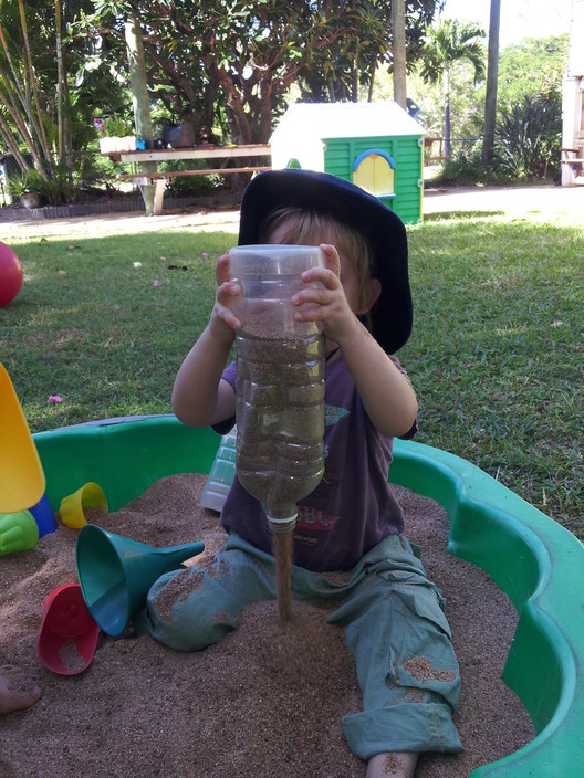 Little Learners Family Day Care Pic 1 - Master RP plays in the sand Sand play allows children to explore maths and science concepts such as heavy and light full and empty wet and dry etc