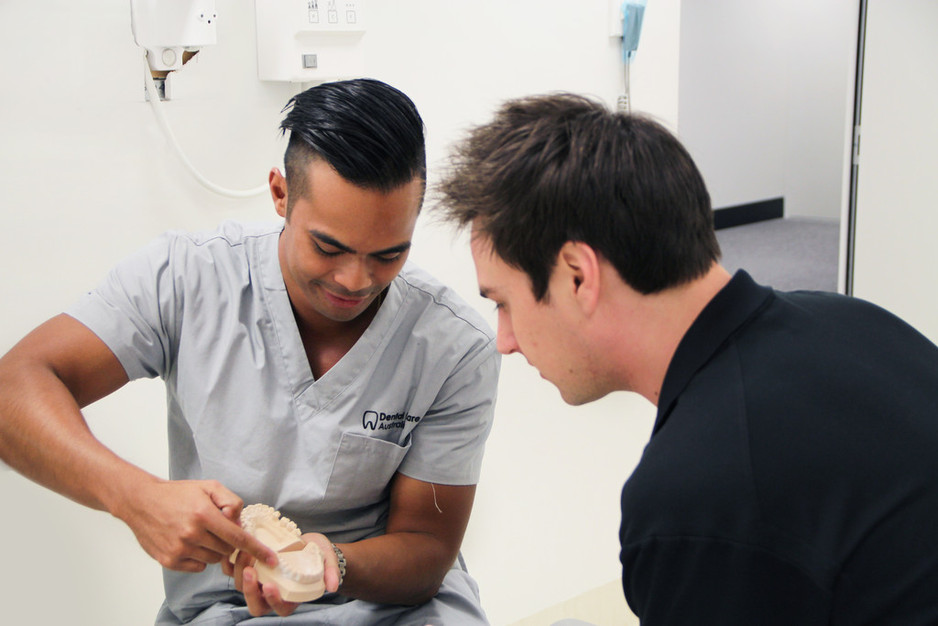 Dental Care Australia Pic 1 - Dr Chris Aguilar with a patient