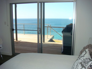 Infinity Beach House Pic 5 - The master bedroom with luxurious ensuite opens out to the balcony