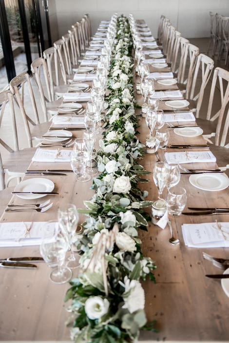 Toowoomba White Wedding and Event Hire Pic 1 - Foilage and Fresh Floral table runners make a gorgeous impact on your tables paired with candlelight WE can help with all of your Styling Floral Requirements