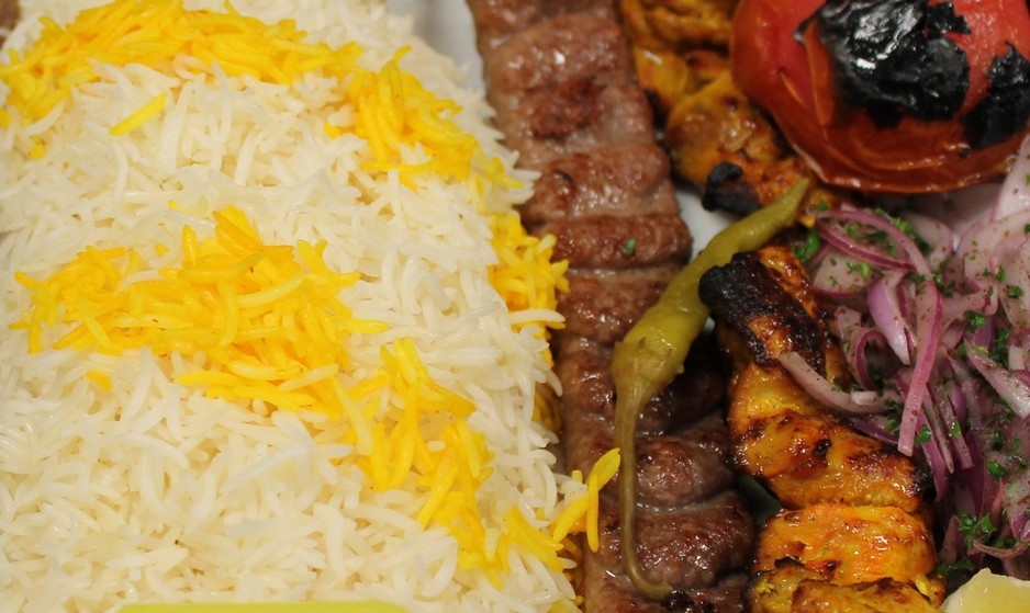 Ferdows Garden Pic 1 - Shahbaz Minced lamb kebabs and Lemon onion marinated chickencooked over charcoal served with a bed of saffron rice grilled tomato pickled chilli and onion sumac salad