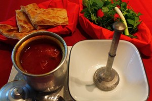 Ferdows Garden Pic 2 - Dizi the Persian Hot Pot Slow cooked lamb with chickpeas potato tomato served with a side of Turkish bread fresh herbs and pickled vegetables