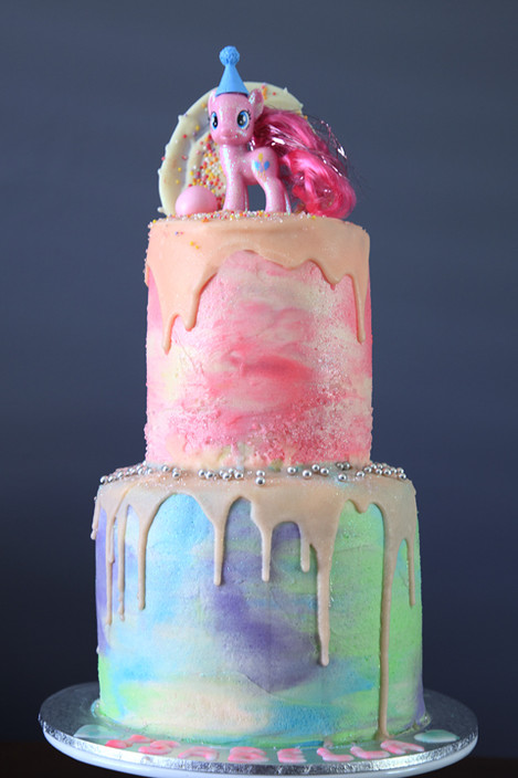 Luna Cakes Pic 1 - rainbow pony cake white chocolate raspberry filling chocolate drip glitter and lots of colour