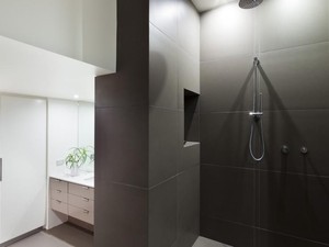 Matzco Tiling Pic 2 - entry walls are designed to be very thick which gives the bathroom a cave like feel The lighting is minimal with only the vanity and toilet area having bright lighting