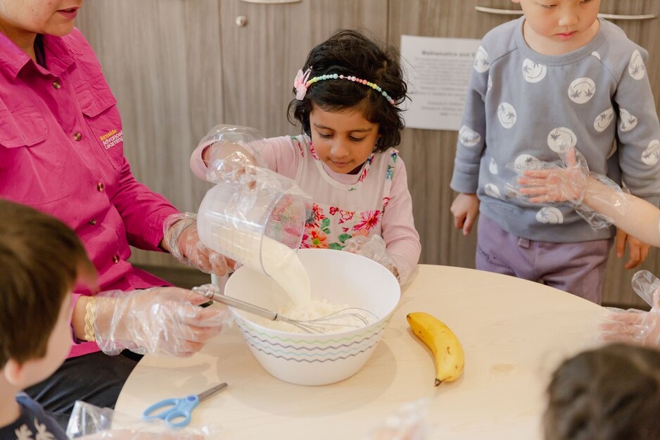 Childcare Centre Adelaide Pic 1 - Children baking together at a childcare centre in Adelaide developing practical skills and teamwork in a fun and engaging daycare environment