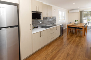 River Myall Holiday Resort Pic 4 - Deluxe Villa kitchen and dining area