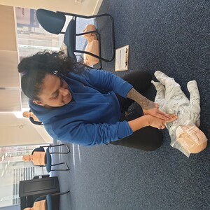 First Aid HQ Pic 4 - One of our students performing CPR on infant Manikin