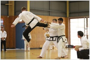 Pacific International Taekwondo Pic 2 - Jumping leading leg side kickboard break