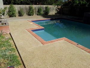 In Style Landscapes Pic 3 - Exposed Aggregate around pool with brick border