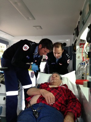 Paramedic Services Pic 3 - Two Paramedic Services staff members attend to a patient with chest pains prior to the arrival of the emergency ambulance This patient was assessed treated and ready to go